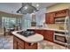 Well-appointed kitchen featuring a center island cooktop, cabinetry, and a dining nook with bright windows at 16420 Iola Woods Trl, Dade City, FL 33523
