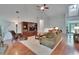 Bright living room with hardwood floors, a cozy seating area, and natural light at 16420 Iola Woods Trl, Dade City, FL 33523