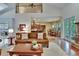 Open-concept living room featuring a lofted space, seamlessly connected to the kitchen and dining areas at 16420 Iola Woods Trl, Dade City, FL 33523