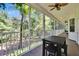 Picture of the screened-in porch featuring a ceiling fan, white rails, and an expansive outdoor entertaining area at 16420 Iola Woods Trl, Dade City, FL 33523