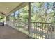Relaxing screened porch overlooking a lush, wooded backyard for serene outdoor enjoyment at 16420 Iola Woods Trl, Dade City, FL 33523