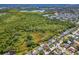 An aerial view showing the home's location in relation to the nearby lush natural environment at 1650 Springdale Dr, Holiday, FL 34691