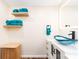Stylish bathroom with a unique vessel sink, floating shelves, and modern fixtures at 1650 Springdale Dr, Holiday, FL 34691