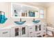 Elegant bathroom featuring double vessel sinks, modern vanity, and stylish lighting at 1650 Springdale Dr, Holiday, FL 34691