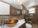 Bathroom featuring decorative vessel sink, and frameless shower with tiled walls at 1650 Springdale Dr, Holiday, FL 34691