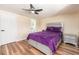 Comfortable bedroom with a plush purple bed, ceiling fan, and ensuite bathroom at 1650 Springdale Dr, Holiday, FL 34691