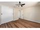 Bedroom boasts wood floors, a ceiling fan and sliding closet doors at 1650 Springdale Dr, Holiday, FL 34691