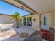 Front courtyard featuring a palm tree, decorative stones, and covered entry at 1650 Springdale Dr, Holiday, FL 34691