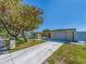 A view of this home's exterior highlighting the concrete driveway and adjacent home at 1650 Springdale Dr, Holiday, FL 34691
