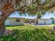Charming single-story home with well-maintained lawn and landscaping, and mature shade tree at 1650 Springdale Dr, Holiday, FL 34691