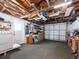 Spacious garage with exposed beams, offering ample storage and workspace, plus laundry appliances at 1650 Springdale Dr, Holiday, FL 34691