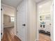 Hallway view with wood floors leading to the bathroom featuring a modern glass bowl sink at 1650 Springdale Dr, Holiday, FL 34691