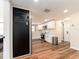 Well-lit kitchen with stainless steel appliances, modern white cabinets, and hardwood flooring at 1650 Springdale Dr, Holiday, FL 34691