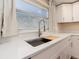 Modern kitchen sink features a stainless steel faucet, quartz countertops, and a window view at 1650 Springdale Dr, Holiday, FL 34691
