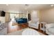 Open floor plan living room with wood floors, an accent chair, and a large blue sectional sofa at 1650 Springdale Dr, Holiday, FL 34691