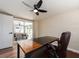 A home office with a brick accent wall and view of the pool and lanai at 1650 Springdale Dr, Holiday, FL 34691