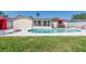 Backyard pool and patio with outdoor seating, perfect for entertaining or relaxing by the water at 1650 Springdale Dr, Holiday, FL 34691