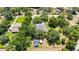 Overhead view of a charming home with a large roof, surrounded by lush trees and a well-maintained yard at 1806 Chickasaw Trl, Valrico, FL 33596