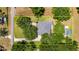 Bird's eye view showing the house, long driveway, green lawn, privacy trees, and shed on the property at 1806 Chickasaw Trl, Valrico, FL 33596