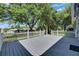 Backyard featuring a deck with white picket fence and a large green lawn at 1806 Chickasaw Trl, Valrico, FL 33596