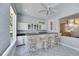 Stylish bar area featuring granite countertops, sleek cabinetry, barstool seating, and ample natural lighting at 1806 Chickasaw Trl, Valrico, FL 33596