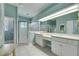Light and bright bathroom offers tiled floors, ample vanity space with double sinks, and a glass shower enclosure at 1806 Chickasaw Trl, Valrico, FL 33596