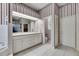 Bathroom boasts striped wallpaper, a large mirror, double sinks, and a separate toilet and shower area at 1806 Chickasaw Trl, Valrico, FL 33596