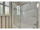 Close-up of a shower with a sliding glass door and tiled walls at 1806 Chickasaw Trl, Valrico, FL 33596