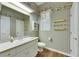 Bathroom featuring wallpaper with floral accents, a window with white shutters, a single sink vanity, and wood-look floor at 1806 Chickasaw Trl, Valrico, FL 33596