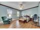 Spacious bedroom with wood-look flooring, a four-poster bed, and natural light from the windows with shutters at 1806 Chickasaw Trl, Valrico, FL 33596