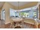 Inviting dining area showcasing laminate floors, a round table and chairs, and a decorative pendant light fixture at 1806 Chickasaw Trl, Valrico, FL 33596