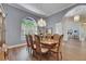 Charming dining area with chandelier, arched windows, and hardwood flooring at 1806 Chickasaw Trl, Valrico, FL 33596