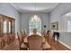 Formal dining room with a chandelier, window views, and seating for ten at 1806 Chickasaw Trl, Valrico, FL 33596