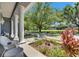 Inviting front porch with white columns and views of the expansive landscaped yard at 1806 Chickasaw Trl, Valrico, FL 33596