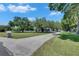 Long driveway leading to a charming home with a lush green lawn at 1806 Chickasaw Trl, Valrico, FL 33596