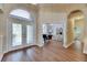 Spacious foyer with decorative glass doors, high ceilings, and wood-look flooring at 1806 Chickasaw Trl, Valrico, FL 33596