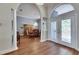 Grand foyer leading to a dining room with elegant chandelier and large windows at 1806 Chickasaw Trl, Valrico, FL 33596