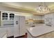Fully equipped kitchen with white cabinets, including a refrigerator and a double oven at 1806 Chickasaw Trl, Valrico, FL 33596