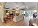 Open living room with wood floors, fireplace, ceiling fan, and view of the dining room at 1806 Chickasaw Trl, Valrico, FL 33596