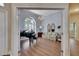 Bright formal living room with grand piano, large window, and hardwood floors at 1806 Chickasaw Trl, Valrico, FL 33596