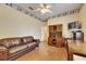 Cozy living room with a ceiling fan, hardwood floors, and a comfortable brown leather sofa at 1806 Chickasaw Trl, Valrico, FL 33596