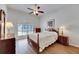 Main bedroom with shuttered window, ceiling fan and wood flooring at 1806 Chickasaw Trl, Valrico, FL 33596