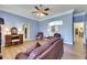 The sitting room features a ceiling fan, light blue walls, and access to the main bathroom at 1806 Chickasaw Trl, Valrico, FL 33596