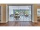 Bright sunroom featuring tiled floors, multiple dining tables, and a sliding glass door for indoor/outdoor living at 1806 Chickasaw Trl, Valrico, FL 33596