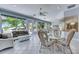 Airy sunroom filled with natural light, wicker furniture, and views of the landscaped backyard at 1806 Chickasaw Trl, Valrico, FL 33596