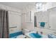 Bathroom with a blue bathtub, shower with curtain, and classic bamboo wallpaper at 200 Portree Dr, Dunedin, FL 34698