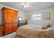Cozy bedroom with a ceiling fan, closet, and dresser, creating a comfortable retreat at 200 Portree Dr, Dunedin, FL 34698