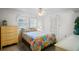 Bright bedroom with colorful bedspread, ceiling fan, and ample natural light at 200 Portree Dr, Dunedin, FL 34698
