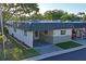 Charming one-story home with carport, stone accents, and well-maintained lawn at 200 Portree Dr, Dunedin, FL 34698