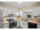 Functional kitchen with stainless steel appliances and bright cabinetry at 200 Portree Dr, Dunedin, FL 34698
